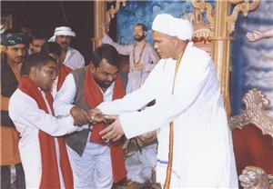Maharaj Shri taking care of a handicap